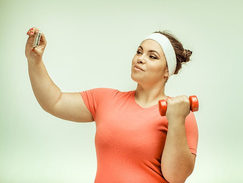 Overweight woman taking selfie