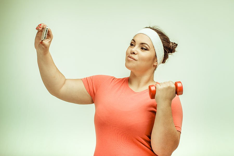 Overweight woman taking selfie